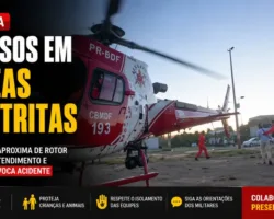 Bombeiros evitam tragédia com Helicóptero do CBMDF após homem se aproximar do rotor 5 Helicóptero do CBMDF em operação de resgate com rotores em funcionamento enquanto bombeiro impede a aproximação de um homem durante atendimento de emergência, destacando o alerta sobre os riscos de se aproximar da aeronave.